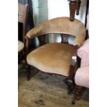 An Edwardian upholstered tub chair on cabriole legs