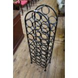 A black painted metal wine rack