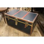 A vintage shipping trunk with brass fittings