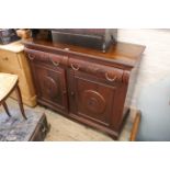 A 20th Century carved mahogany two door two drawer sideboard