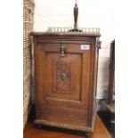 An Edwardian oak coal cabinet with brass gallery top and carrying handles,