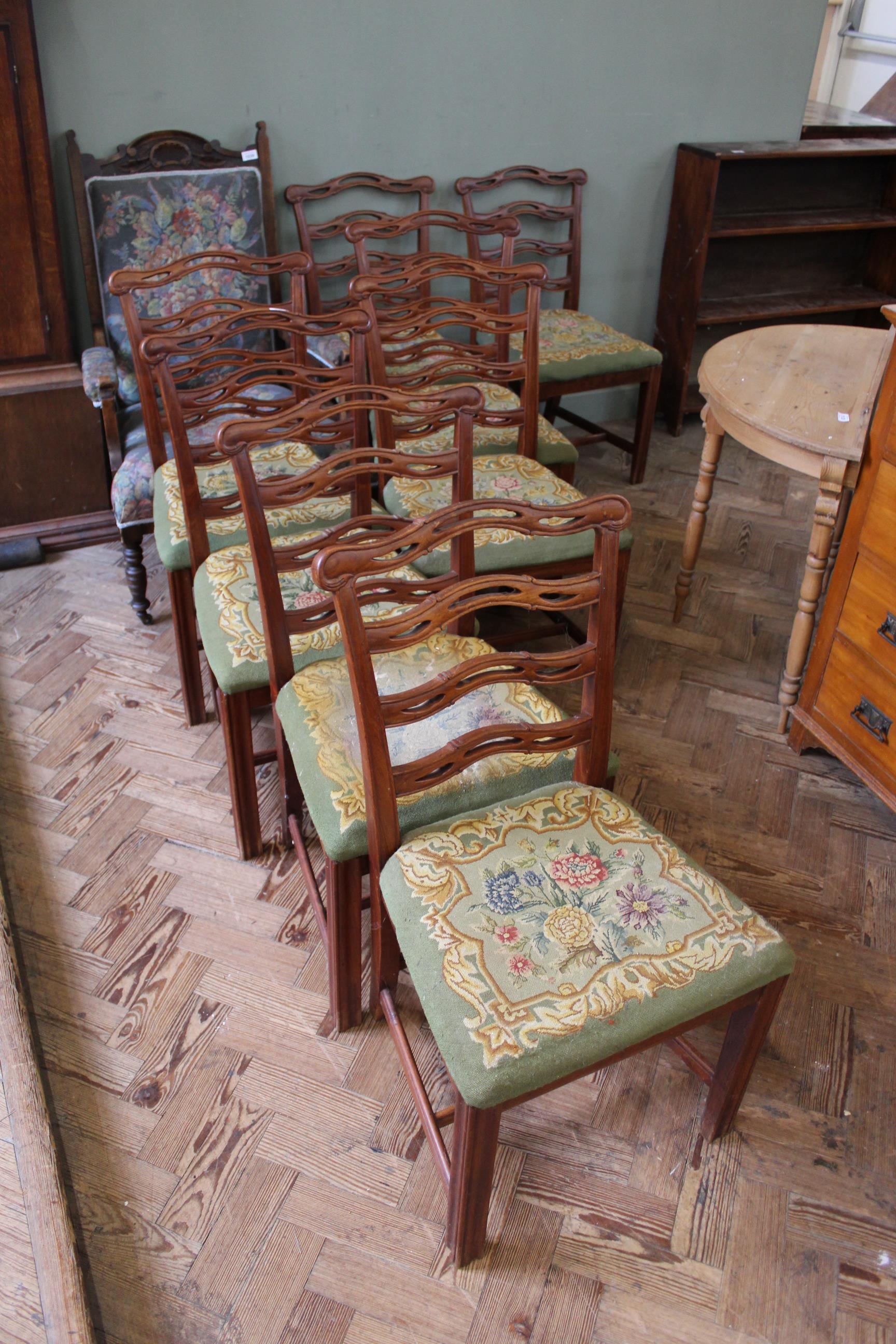 A set of eight Georgian style ladderback chairs