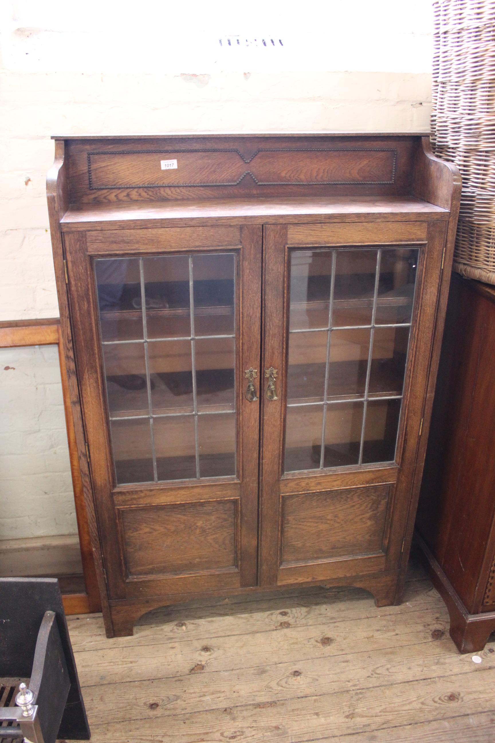 A 1940's oak two door adjustable bookcase with lead lined doors