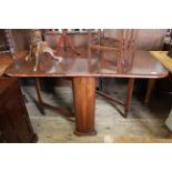 A 1930's stained mahogany drop leaf dining table with unusual curved ends