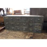 A late 19th Century bank of eighteen drawers, original finish with original writing in places,