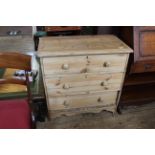 A late Victorian stripped pine three drawer cottage chest