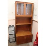 A 1970's display unit with cupboard base and glazed upper section
