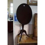 A George III mahogany tilt top dished top tripod table