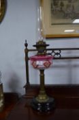 Victorian Brass Column Oil Lamp on Black Ceramic Base with Decorative Pink Glass Bowl