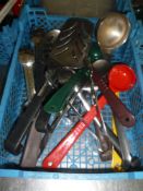 * selection of kitchen utensils - ladles, spoons, slotted spoons, tongs, etc.