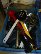 * selection of kitchen utensils - ladles, spoons, slotted spoons, tongs, etc.