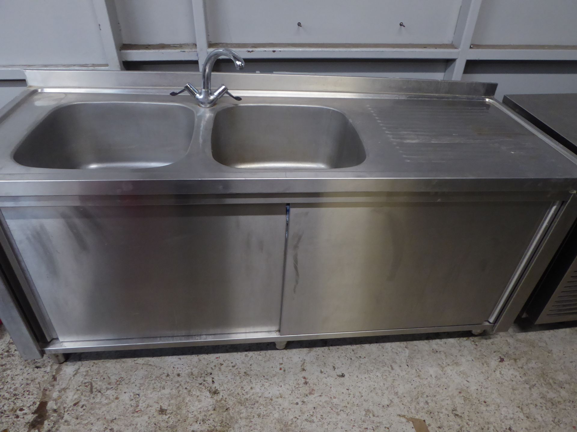 *S/S double bowl sink with right hand drainer and tap, complete with 2 sliding doors and undershelf.