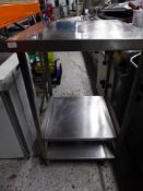 *tall S/S table on castors with 2 shelves 650w x 700d x 1060h