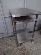 *S/S tall table with 2 shelves on castors. Has small cut out to the rear. 600w x 700d x 1120h