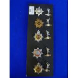 Ten Cap Badges including Signals, Military, and Fire Brigade