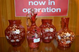 Three Cranberry Glass Vases and a Ewer with Applie