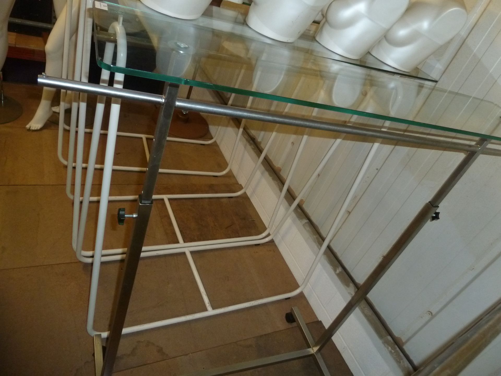 * chrome freestanding hanging rail on castors with glass top (adjustable height) 1450w x 500d