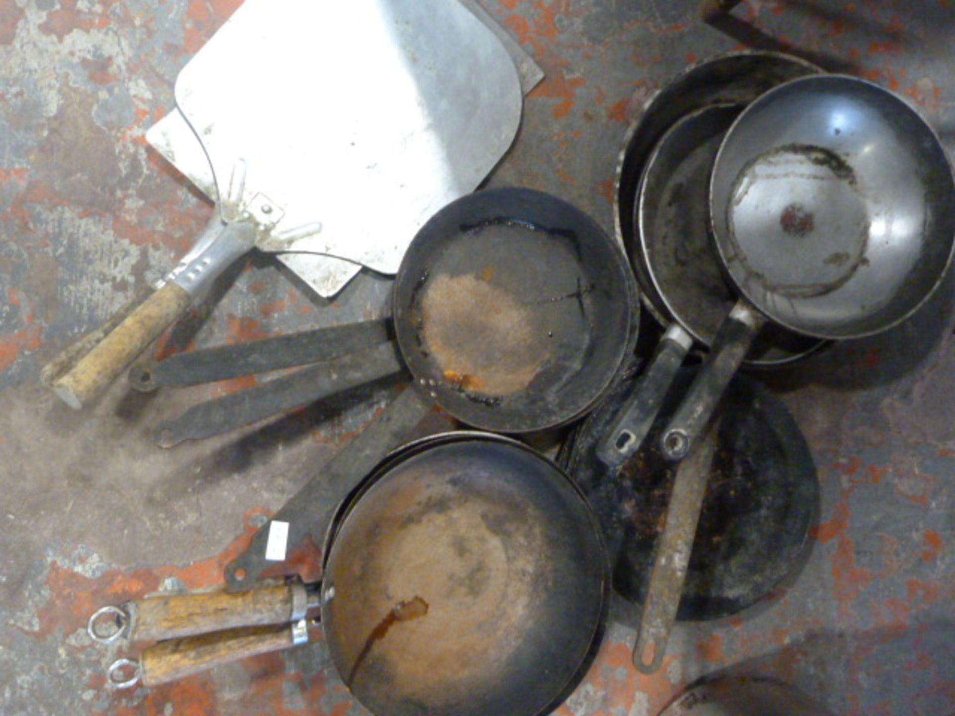 Two Large Wood Handled Spatulas and a Quantity of Frying Pans