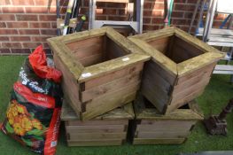 Four Wooden Planters and a Sack of Multipurpose Co