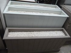 * 3 x wooden display planters - all topped with white stone. 2 x large pale blue - 1250w x 300d x