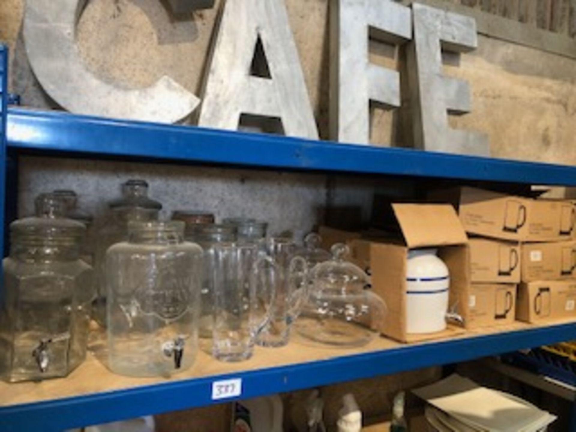 * contents of shelf glass and ceramic water dispensers jugs vases tankards etc Located at
