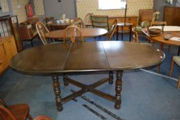 Ercol Dark Oak Oval Extending Dining Table