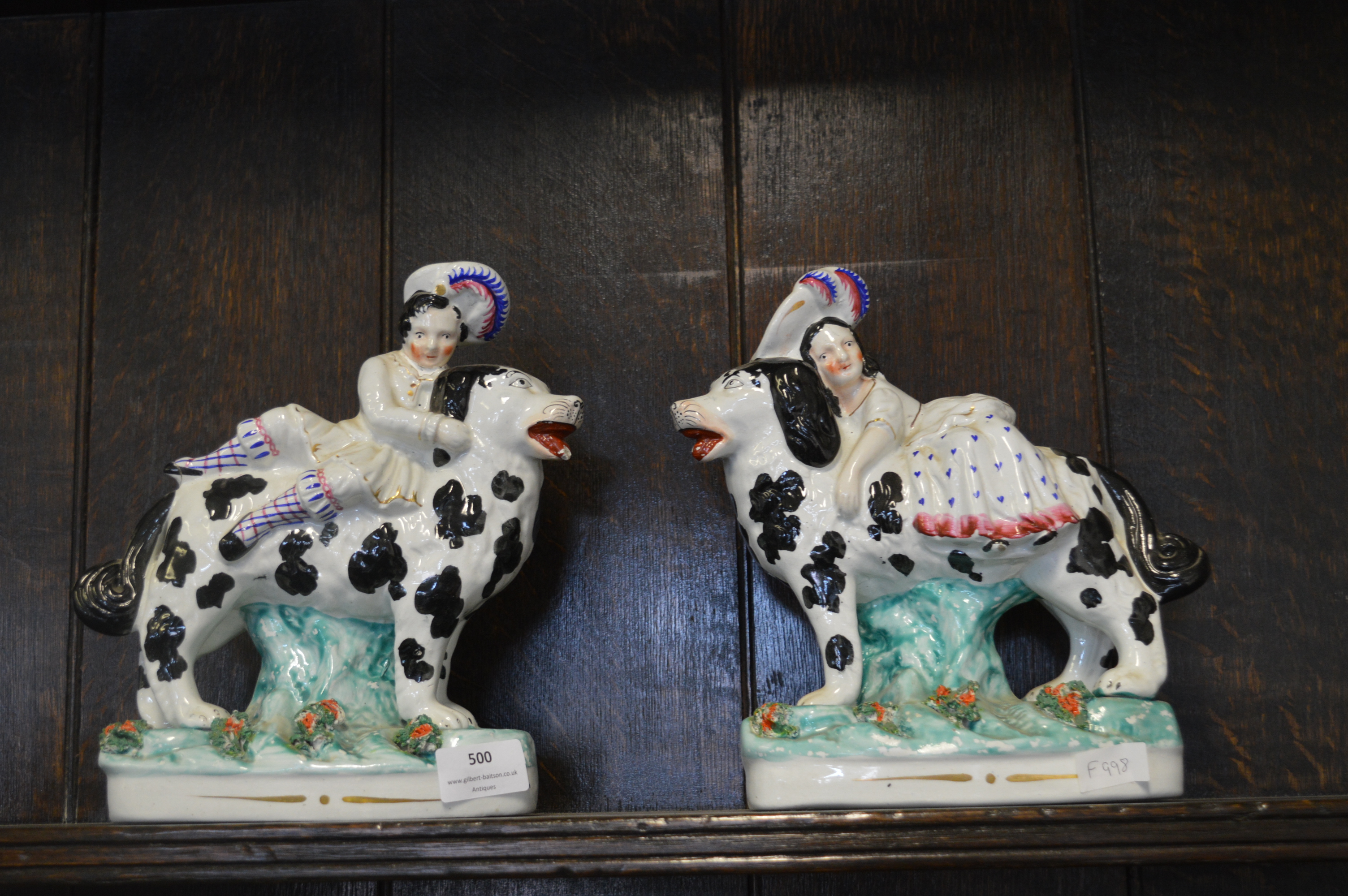 Pair of Victorian Staffordshire Flatback Figures of Children Riding Spaniels