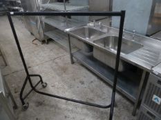 * black clothes rail on castors (comes apart for transportation/storage). 1240w x 550d x 1360h