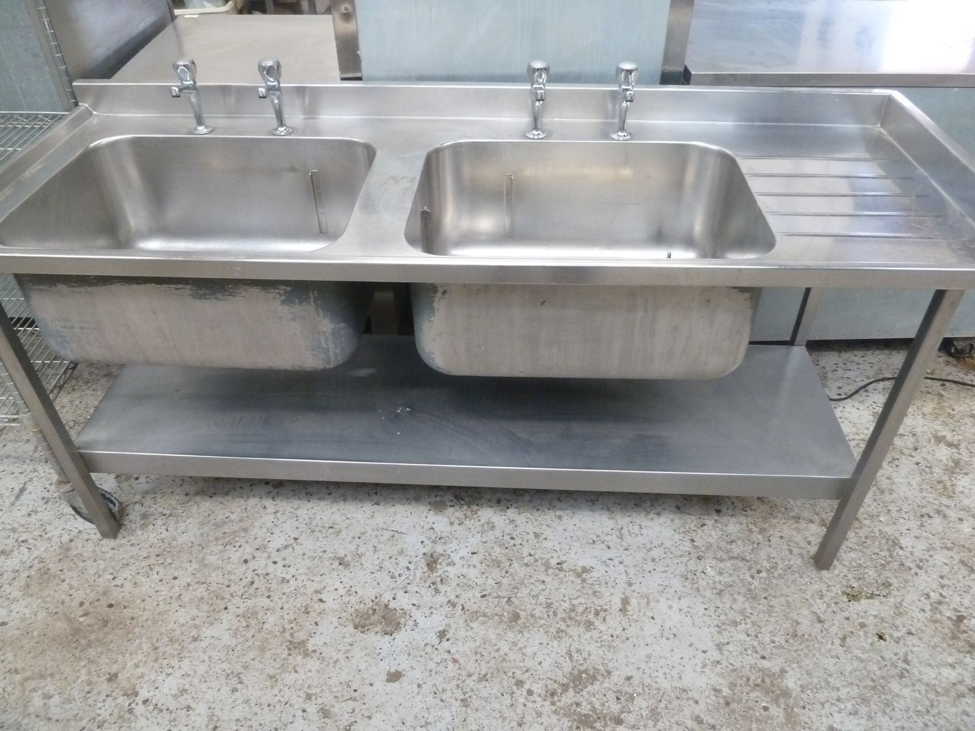 * S/S double bowl sink with small right hand draining board - complete with taps and undershelf.