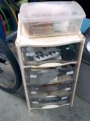 * plastic 4 drawer unit containing party supplies, etc