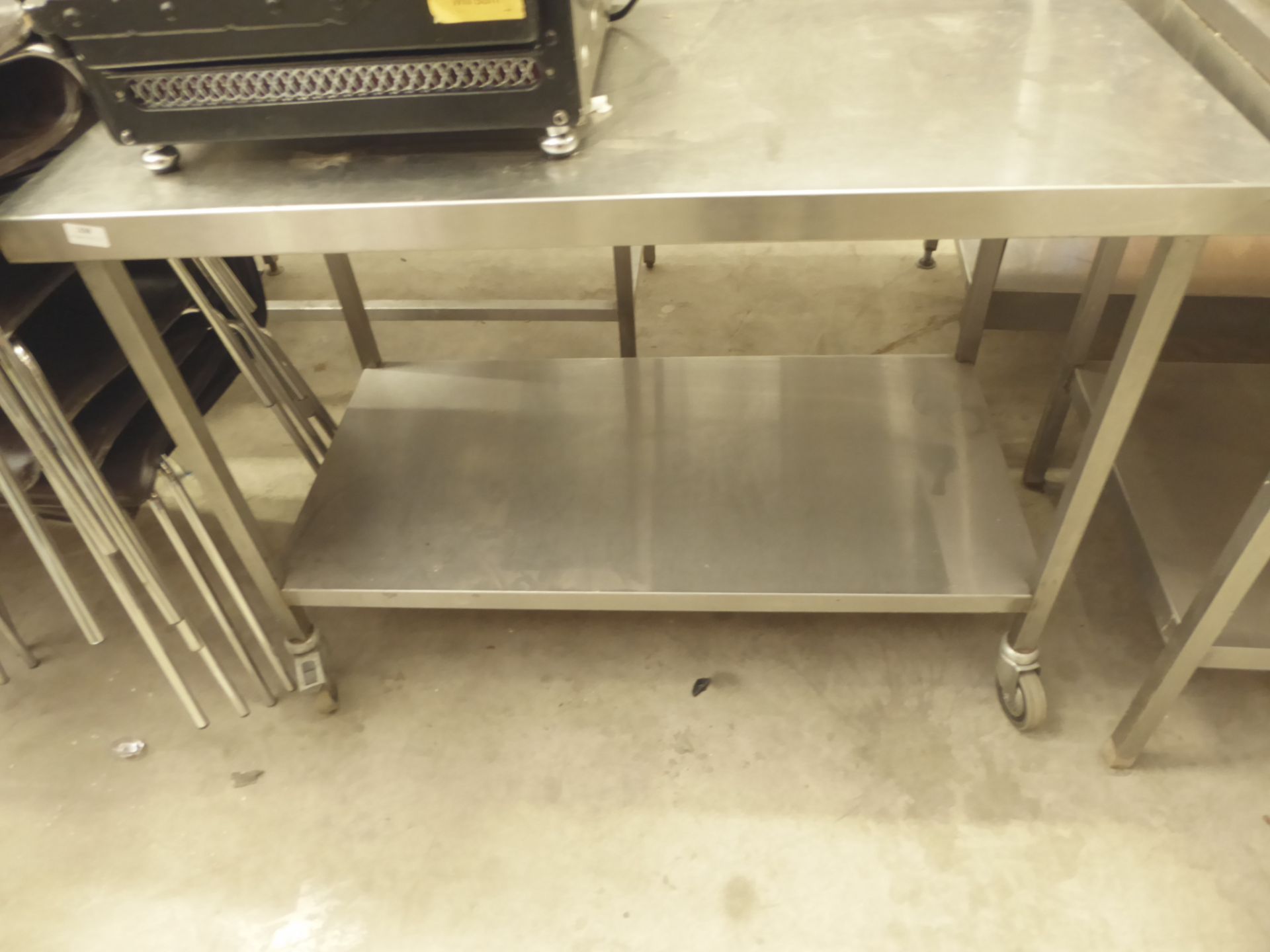 * S/S prep bench on castors - with undershelf. 1200w x 600d x 850h