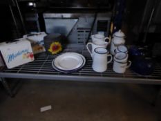 * assortment of items for a display - lunch boxes, plates, jugs, camping kettles