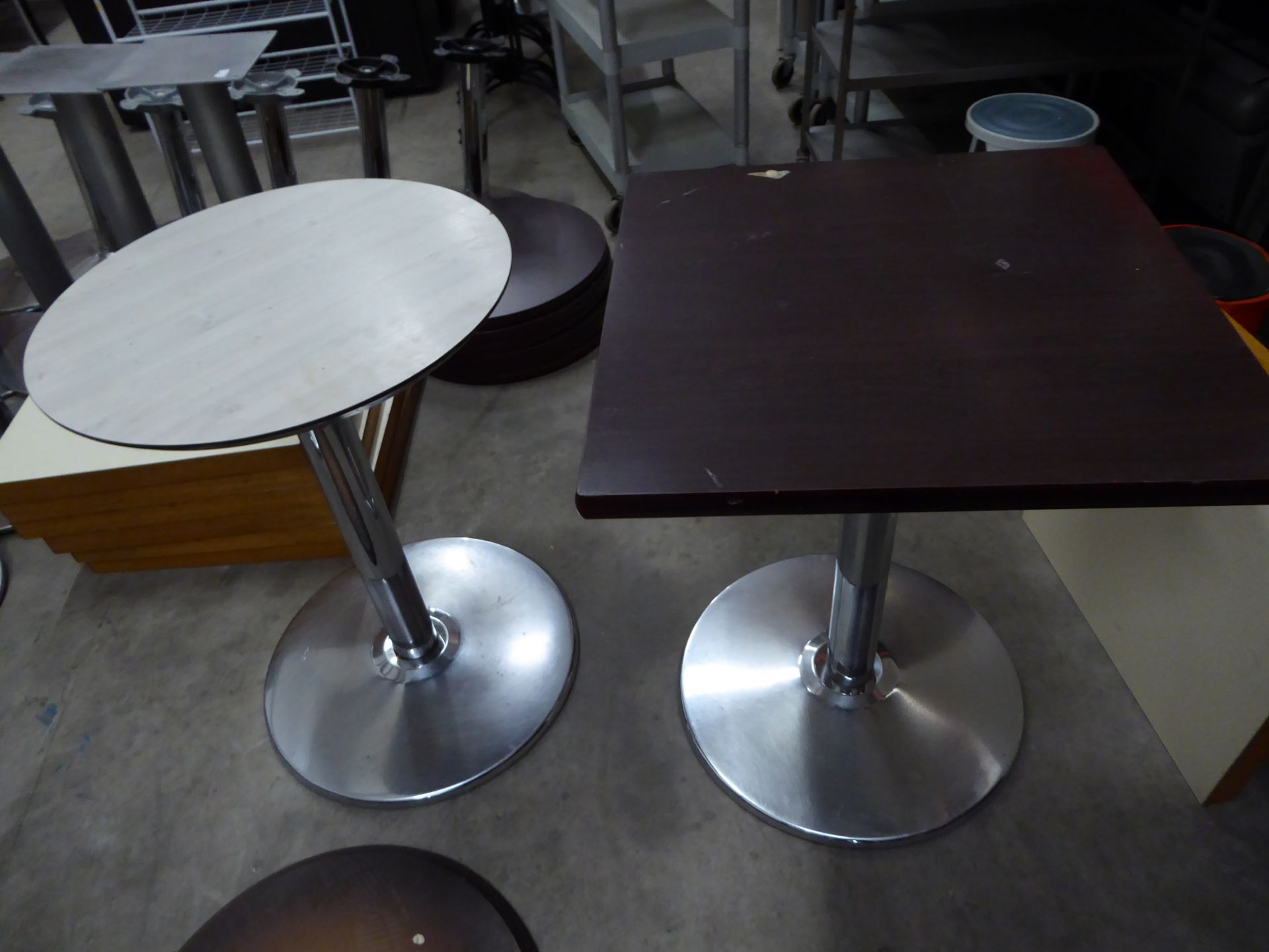 * 3 x tables with chrome bases - 2 x round (white wood effect top - 600d), 1 x square (dark work top