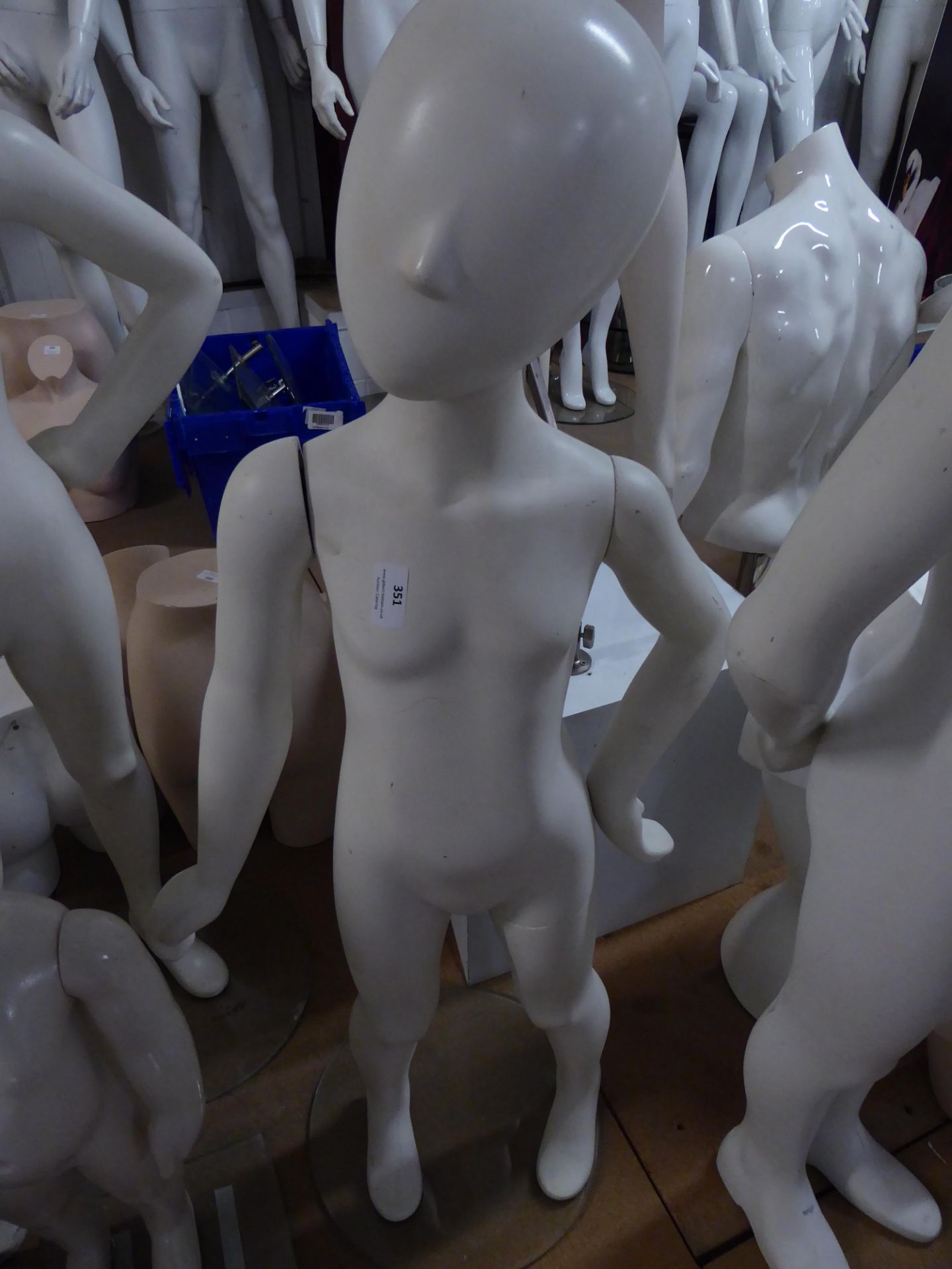 * white childs mannequin on glass stand