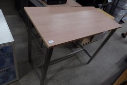 * high level shop display table, stainless steel finished legs with a pleasant wood effect top.