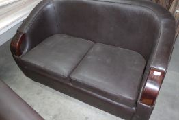 * brown leatherette 2 seater sofa with dark wood arms