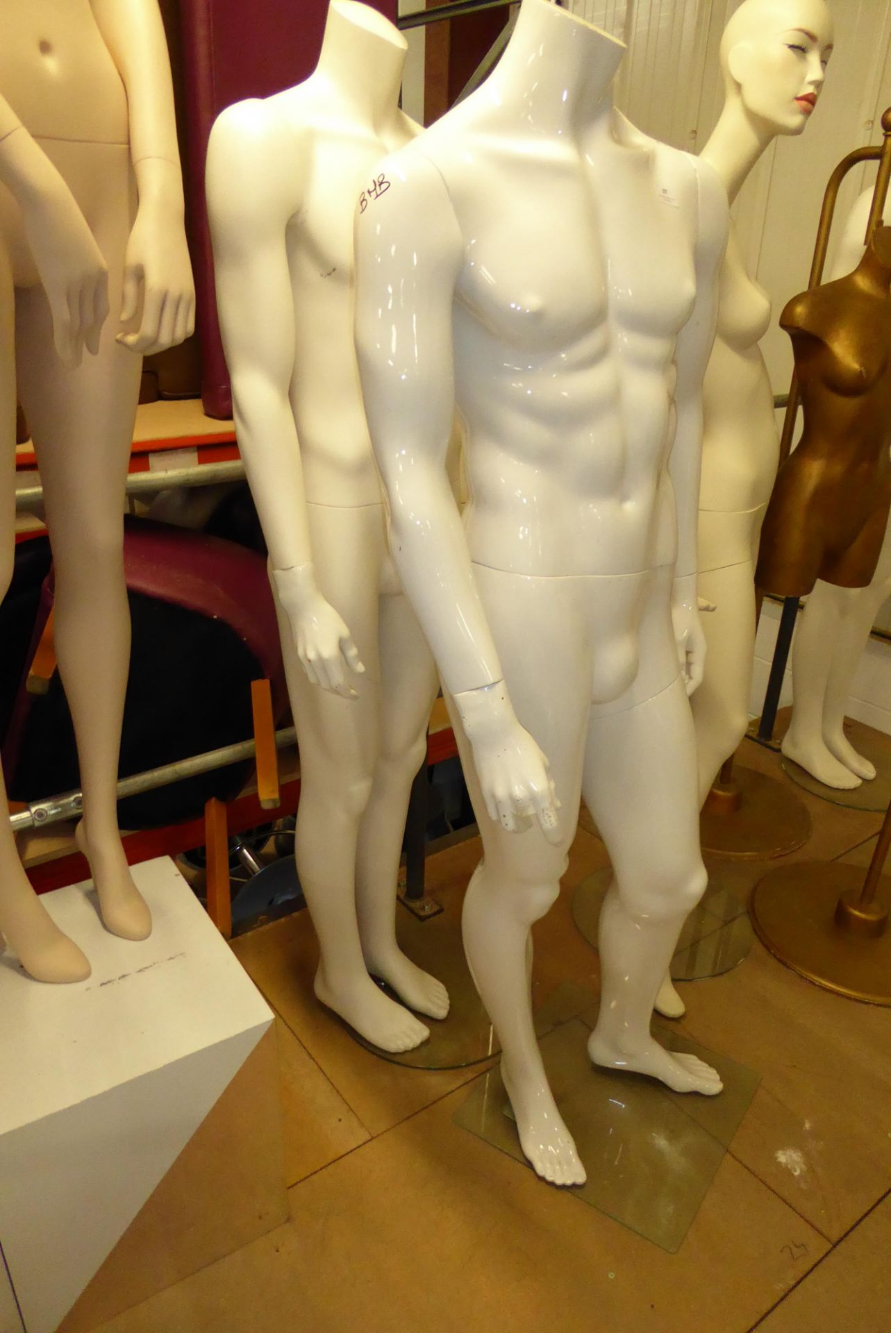 * Two headless male mannequins on stands