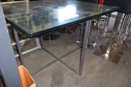 * glass table with chrome base. 1000w x 1200d x 800h