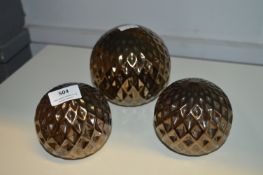 Three Ornamental Metal Balls