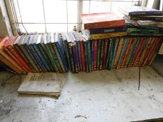 ~60 Haynes Manuals and a Workbench Containing Oil Jugs, etc.