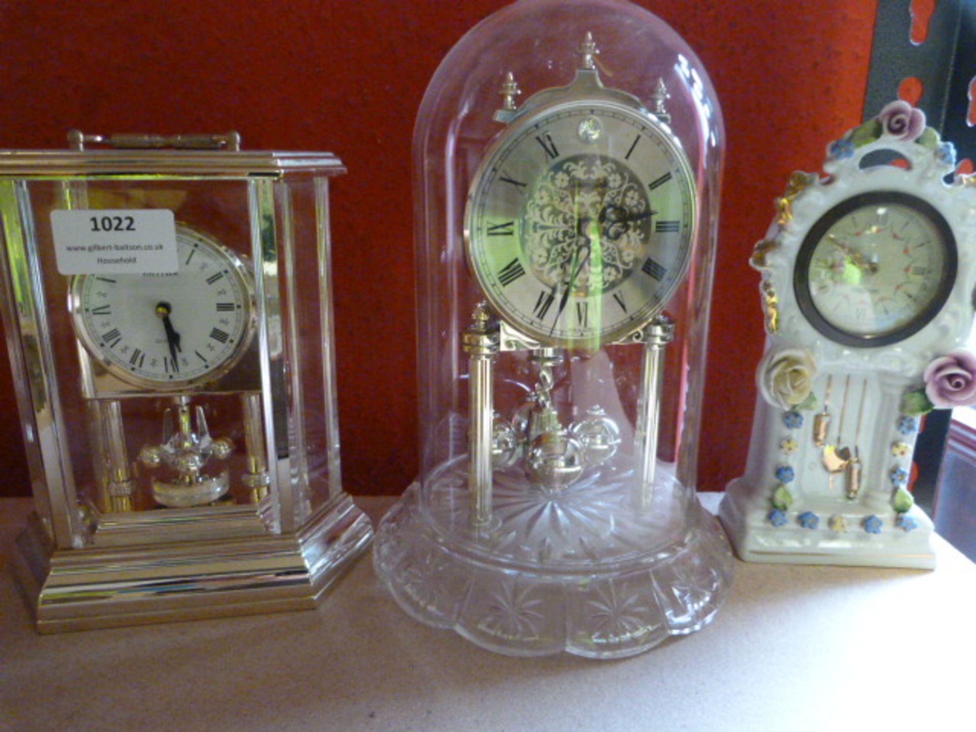 Brass Framed Clock, Glass Dome Clock and an Ornamental Pottery Clock