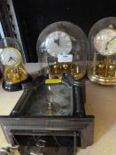 Three Brass Effect Plastic Dome Clocks and a Small Plastic Wall Clock