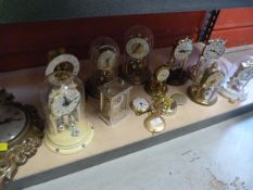 Shelf of Assorted Clocks Including Carriage, Wall and Plastic Domed Clocks