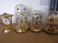 Three Plastic Dome Clocks and One Other