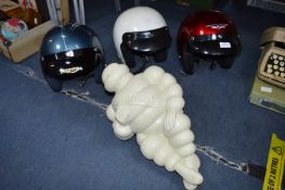 Three Motorcycle Helmets and Michelin Man