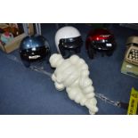 Three Motorcycle Helmets and Michelin Man