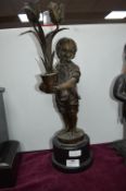 Pewter Candelabra in the form of a Boy Holding Tulips