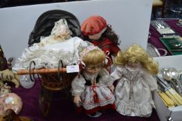 Three Dolls and a Decorative Pram with a Doll