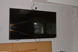 Michell and Brown Wall Mounted 65" TV
