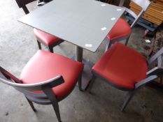 * set of table and 4 chairs, grey wood framed chairs with red upholstered pad, stainless brushed